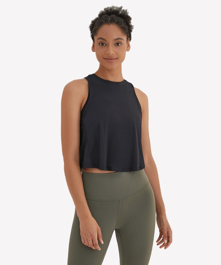 Woman wearing a navy lightweight quick-dry sleeveless t-shirt with mesh back, ideal for activewear and workouts.